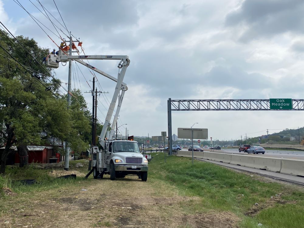 Austin Energy workers install new power lines along US 290 near the Y interchange. Utility relocations are taking place along the entire Oak Hill Parkway corridor to make room for new roadway improvements. April 2022